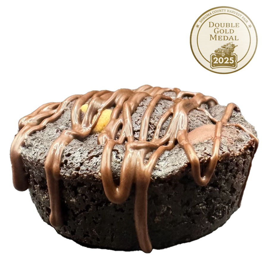 A rich chocolate brownie cookie topped with drizzled melted chocolate.