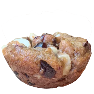 A golden brown cookie with white chocolate chunks and cranberries.